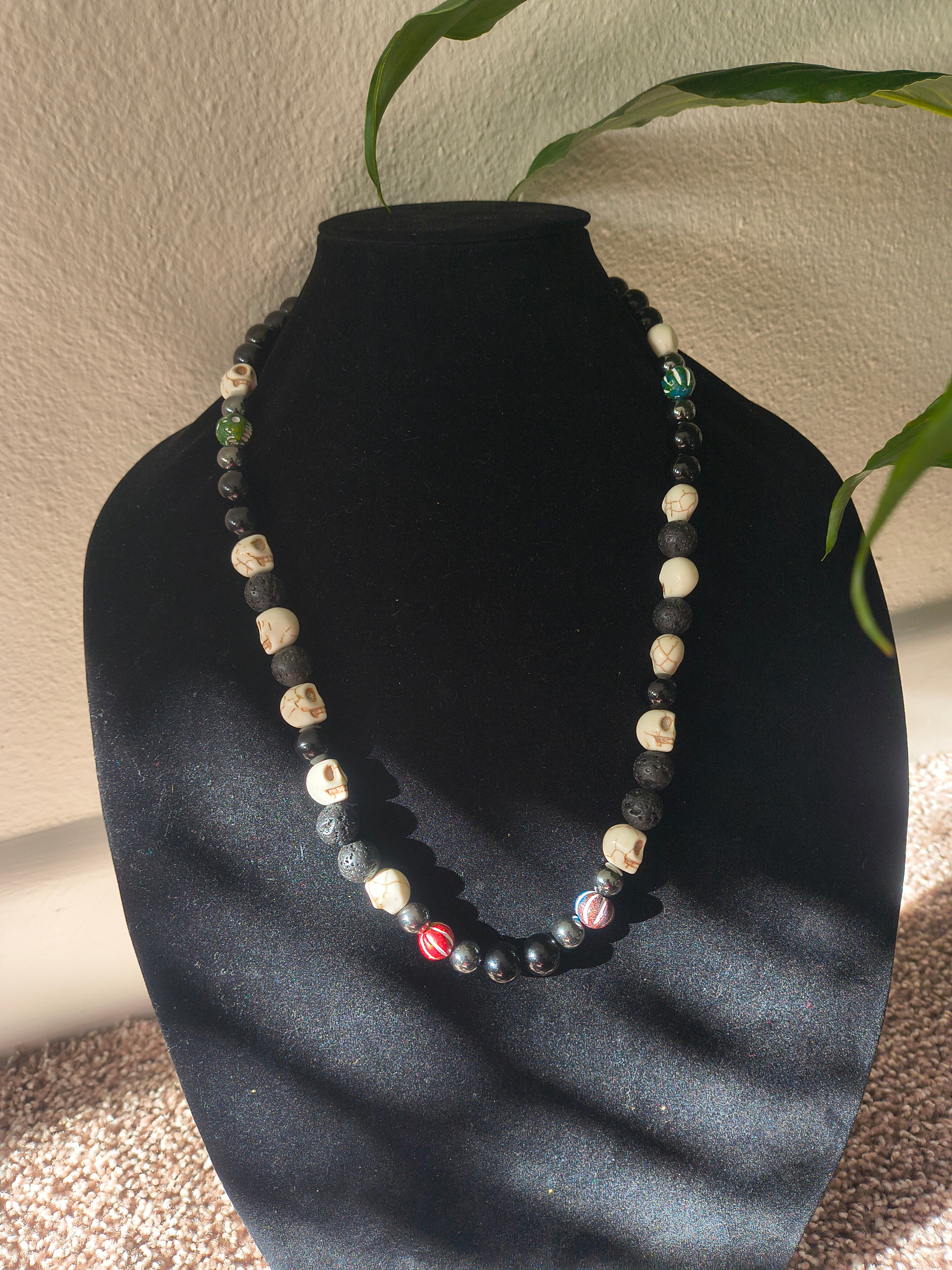 Lava stone, black jasper, hematite, clay beads with skull bead necklace