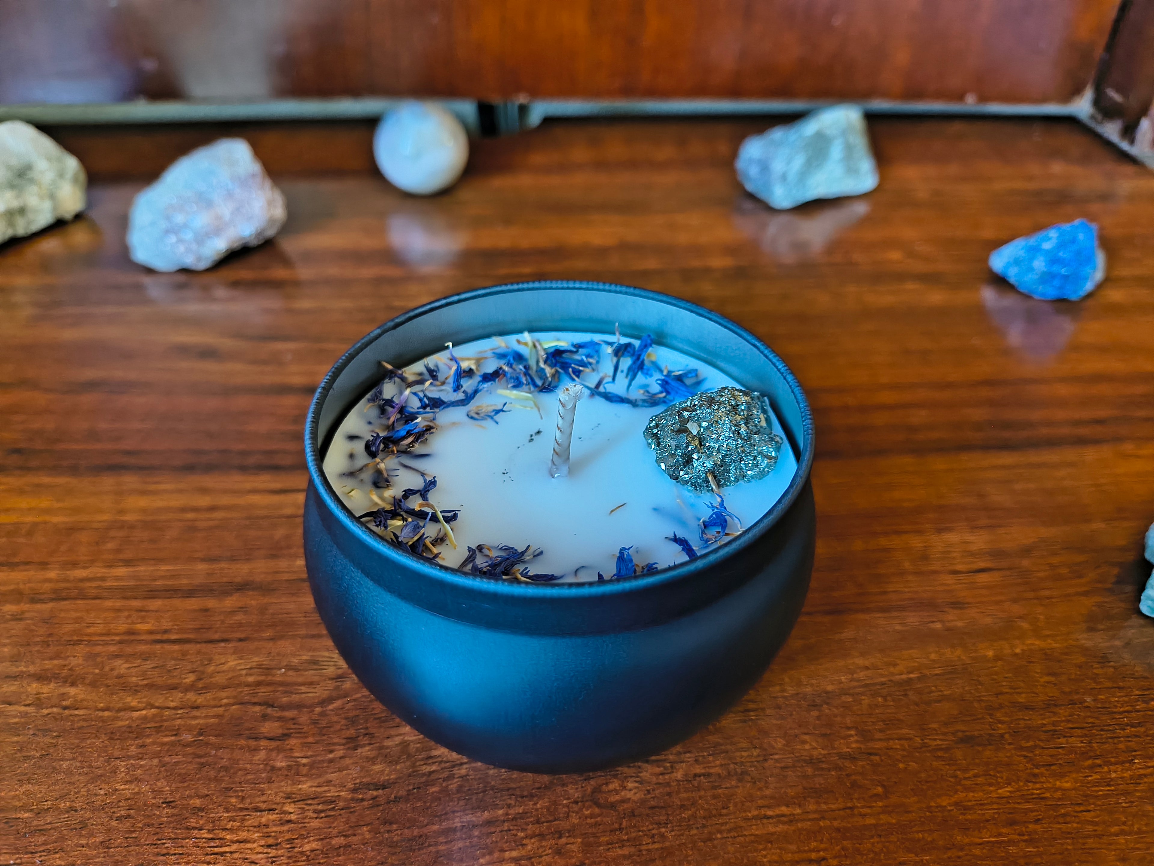 White candle with cornflower and pyrite